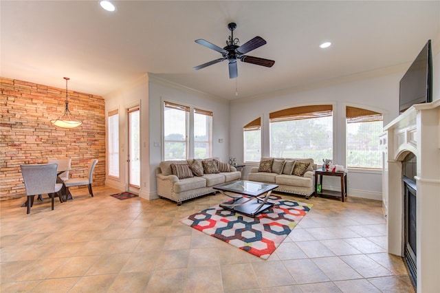 living area featuring ceiling fan, crown molding, baseboards, recessed lighting, and light tile patterned flooring