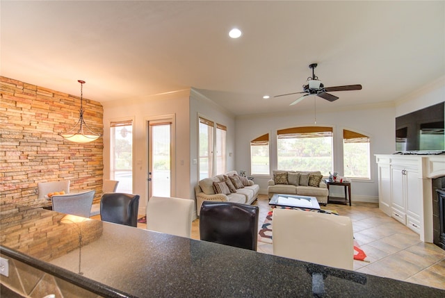 tiled living room with recessed lighting, ornamental molding, baseboards, and ceiling fan