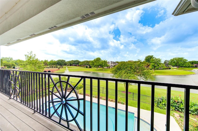 balcony featuring a water view and visible vents