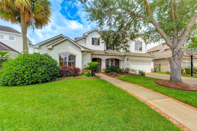 traditional-style house with a front lawn, stone siding, stucco siding, concrete driveway, and an attached garage