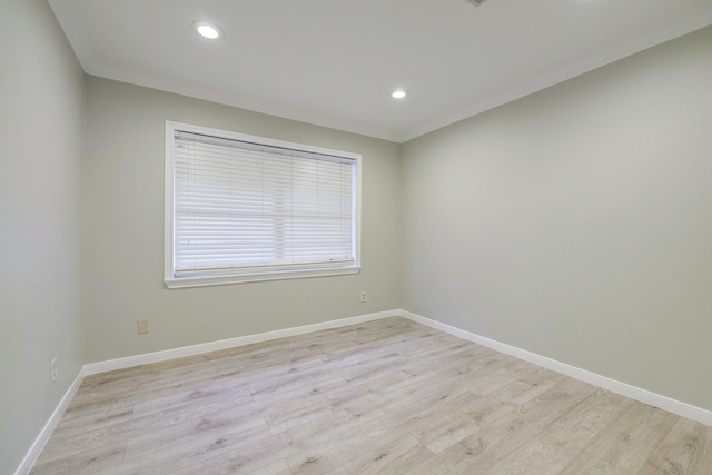 spare room with crown molding, recessed lighting, baseboards, and light wood-type flooring