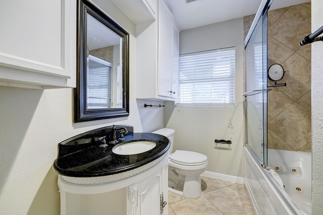 full bathroom featuring tile patterned flooring, vanity, toilet, baseboards, and a combined bath / shower with jetted tub