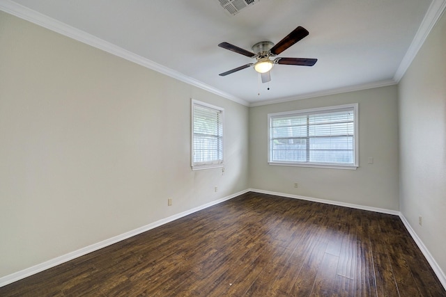 spare room featuring visible vents, ornamental molding, baseboards, and dark wood-style flooring