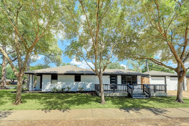 ranch-style house with an attached garage, driveway, a front yard, and a porch
