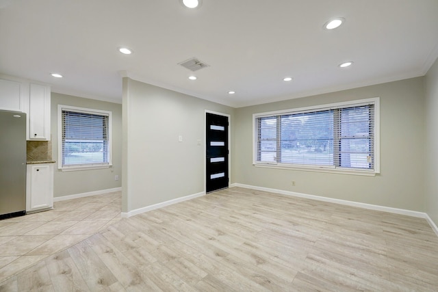 unfurnished room with visible vents, recessed lighting, plenty of natural light, and light wood-type flooring