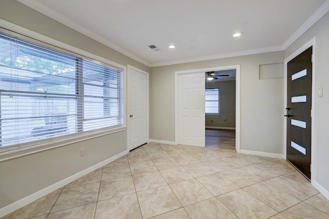 entrance foyer featuring crown molding, light tile patterned flooring, ceiling fan, and visible vents