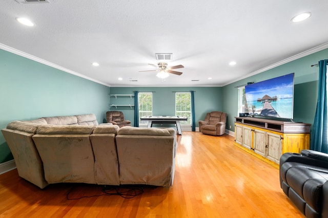 living area featuring crown molding, recessed lighting, and light wood-type flooring