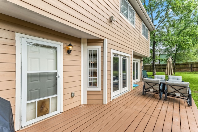 wooden deck featuring fence, an outdoor living space, and french doors