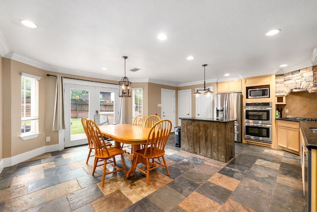 dining room with crown molding and recessed lighting