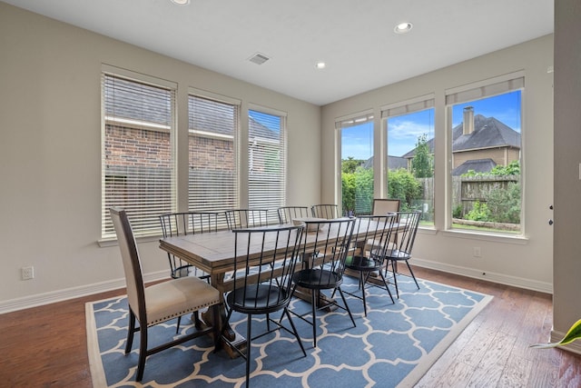 dining space with recessed lighting, baseboards, visible vents, and wood finished floors