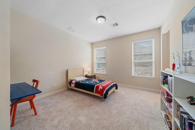 bedroom featuring baseboards, carpet flooring, and visible vents