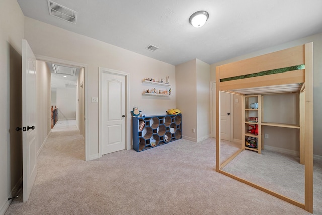 bedroom featuring visible vents, attic access, baseboards, and carpet floors