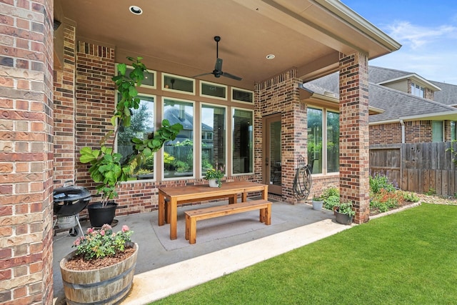 view of patio / terrace featuring fence and a ceiling fan