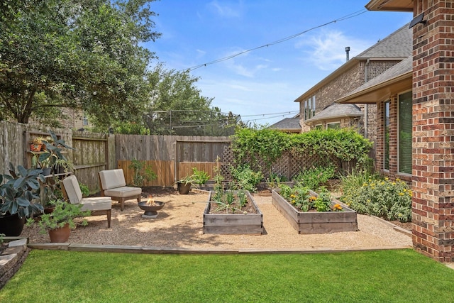 view of yard with fence and a garden