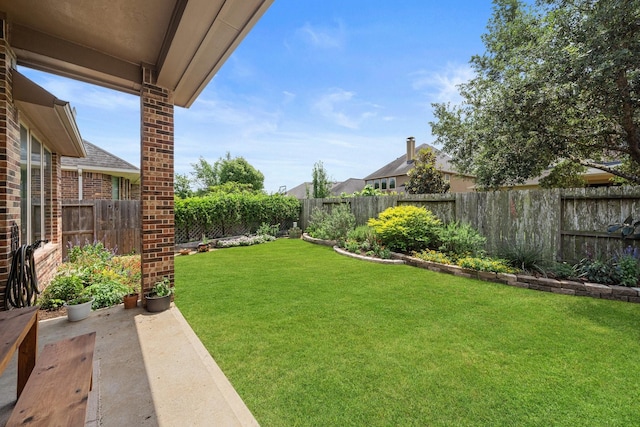 view of yard with a fenced backyard and a patio area