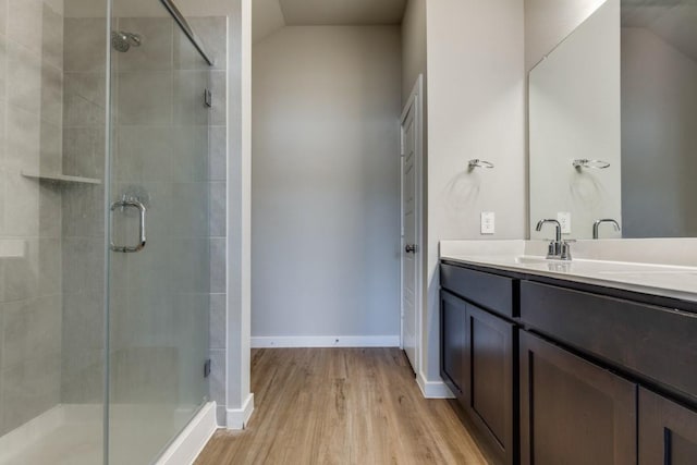 949 Gentle Moss Dr, Magnolia, TX 77354 - full bathroom with a shower stall, wood finished floors, vanity, baseboards, and lofted ceiling