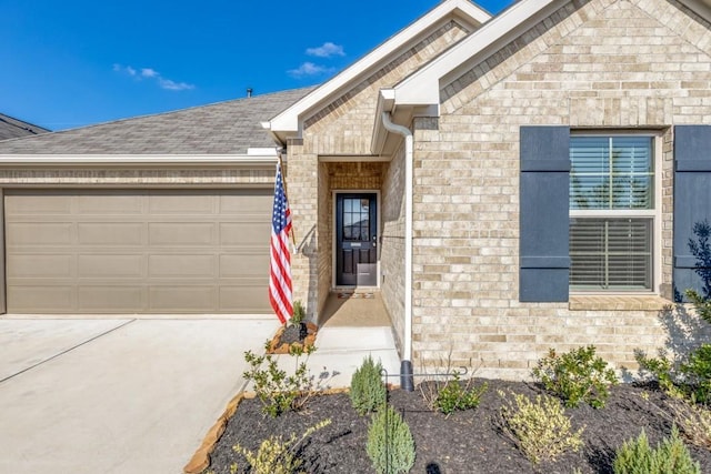 949 Gentle Moss Dr, Magnolia, TX 77354 - property entrance with brick siding, driveway, roof with shingles, and a garage