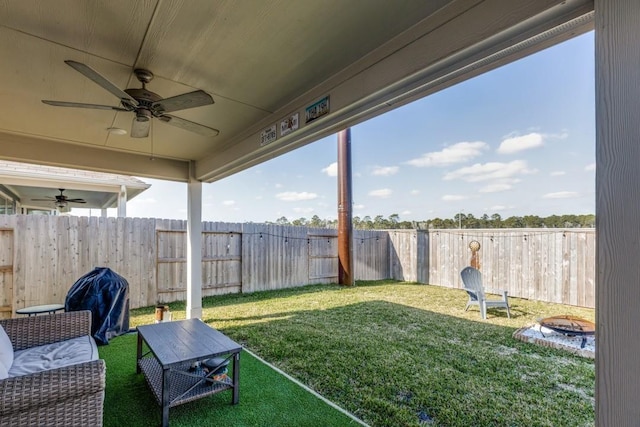 949 Gentle Moss Dr, Magnolia, TX 77354 - view of yard featuring a fenced backyard, ceiling fan, and a fire pit