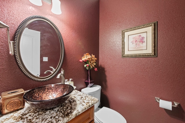 19486 Humaya Dr, Porter, TX 77365 - half bathroom with vanity, a textured wall, and toilet