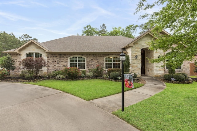 19486 Humaya Dr, Porter, TX 77365 - single story home with a shingled roof, stone siding, and a front yard
