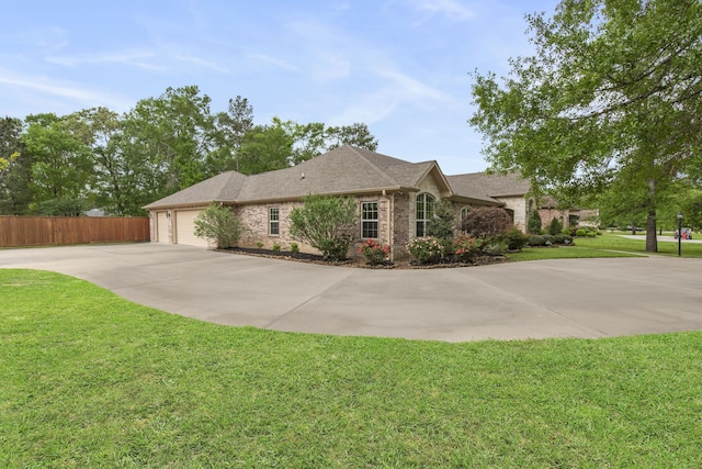 19486 Humaya Dr, Porter, TX 77365 - view of front of house with fence, a front lawn, brick siding, a garage, and driveway