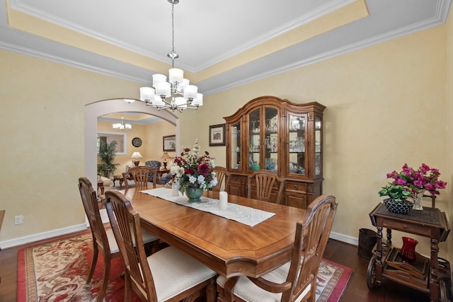 19486 Humaya Dr, Porter, TX 77365 - dining room with an inviting chandelier, arched walkways, ornamental molding, and dark wood-style flooring