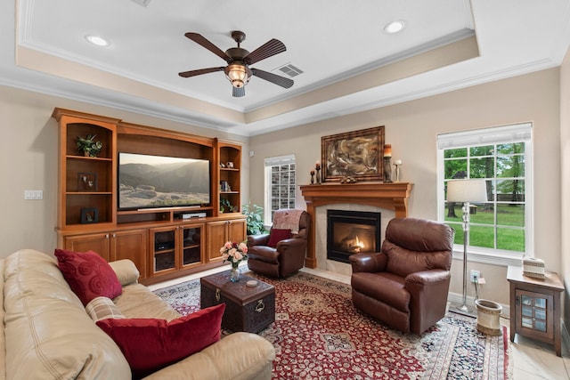 19486 Humaya Dr, Porter, TX 77365 - living area with crown molding, visible vents, a fireplace, ceiling fan, and a tray ceiling