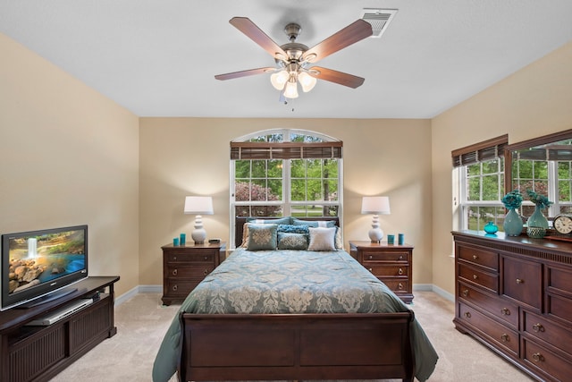 19486 Humaya Dr, Porter, TX 77365 - bedroom with light colored carpet, baseboards, ceiling fan, and visible vents