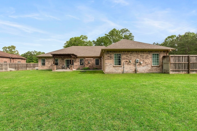 19486 Humaya Dr, Porter, TX 77365 - back of house with a lawn, a patio, a fenced backyard, and roof with shingles
