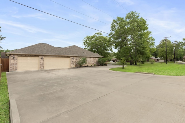 19486 Humaya Dr, Porter, TX 77365 - view of side of property featuring a garage, brick siding, a shingled roof, a lawn, and driveway