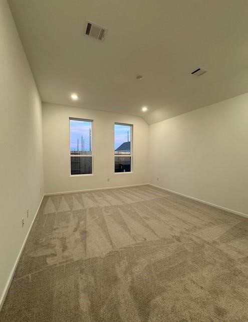 carpeted spare room with baseboards, recessed lighting, and visible vents