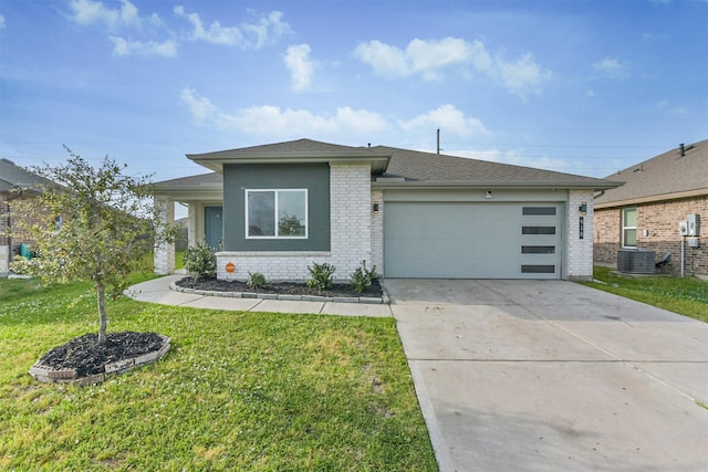 prairie-style home featuring a front lawn, roof with shingles, brick siding, an attached garage, and driveway