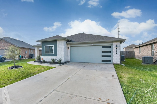 view of front facade with a garage, central AC, a front yard, brick siding, and driveway
