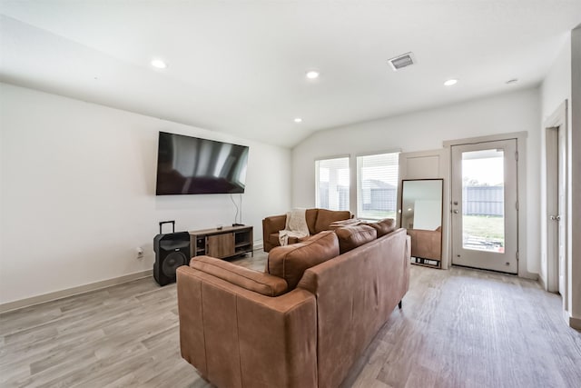 living area with visible vents, recessed lighting, baseboards, light wood-type flooring, and vaulted ceiling