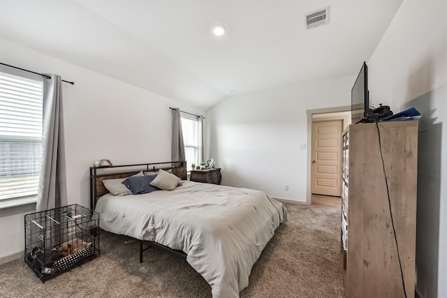 bedroom featuring vaulted ceiling, visible vents, baseboards, and carpet