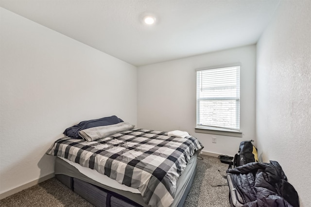 bedroom featuring carpet flooring and baseboards