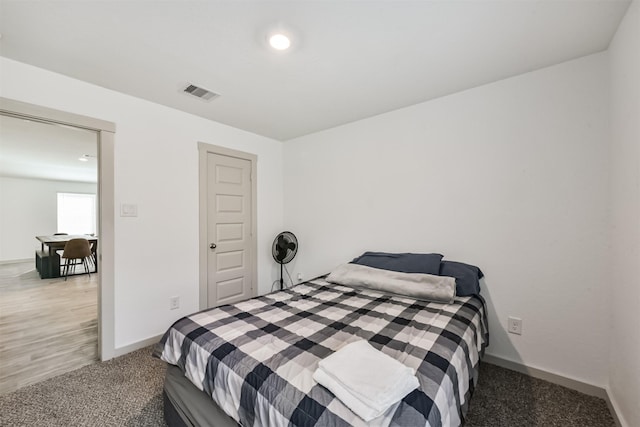 bedroom featuring visible vents, baseboards, and carpet floors