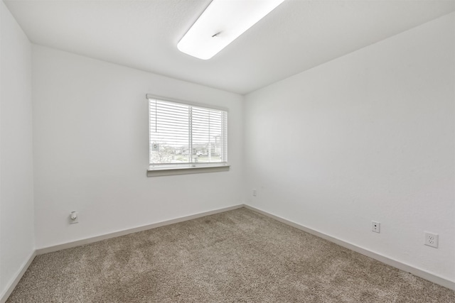 empty room with carpet floors and baseboards