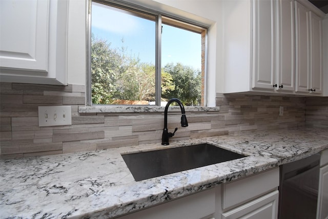 21418 Bentgrass Ct, Katy, TX 77450 - kitchen with white cabinetry, decorative backsplash, and a sink