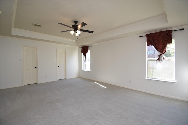 21418 Bentgrass Ct, Katy, TX 77450 - empty room featuring ornamental molding, a tray ceiling, light colored carpet, and visible vents
