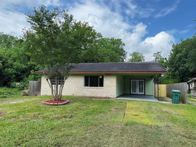 back of house with fence, a patio, french doors, brick siding, and a lawn