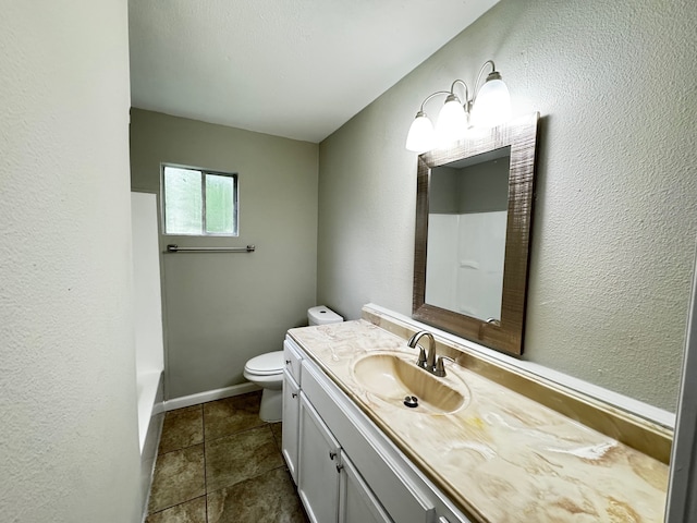 full bathroom with walk in shower, vanity, baseboards, toilet, and a textured wall