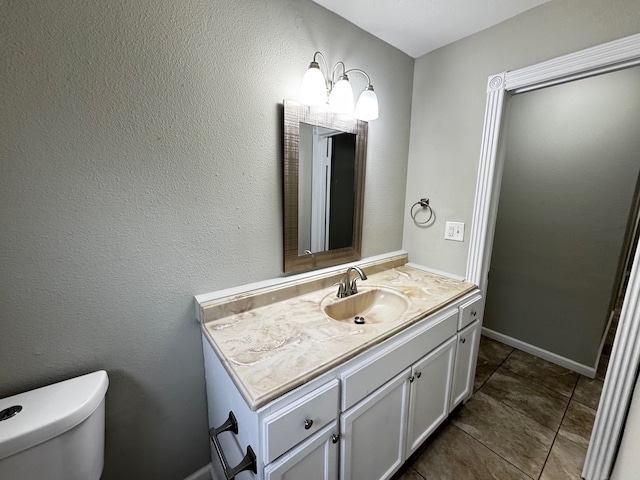 bathroom featuring toilet and vanity