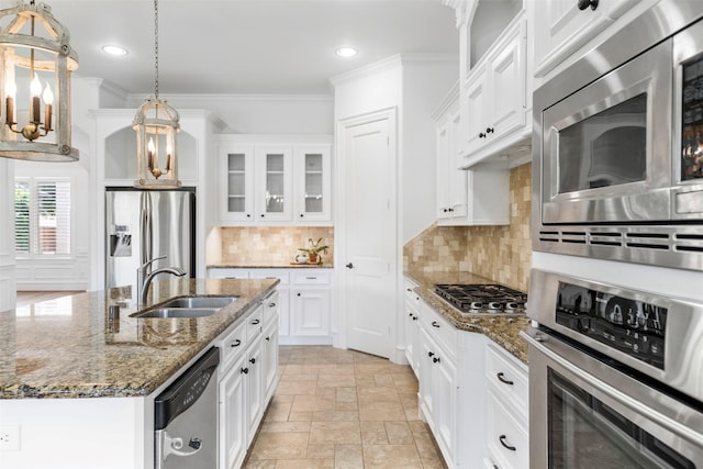 13614 Boerne Canyon Ln, Cypress, TX 77429 - kitchen featuring stainless steel appliances, a sink, ornamental molding, stone tile flooring, and glass insert cabinets