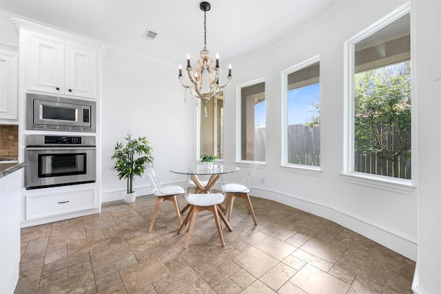13614 Boerne Canyon Ln, Cypress, TX 77429 - dining room featuring stone tile floors, a chandelier, and baseboards