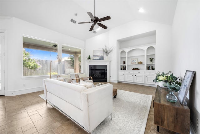 13614 Boerne Canyon Ln, Cypress, TX 77429 - living area featuring built in features, ceiling fan, a glass covered fireplace, baseboards, and high vaulted ceiling