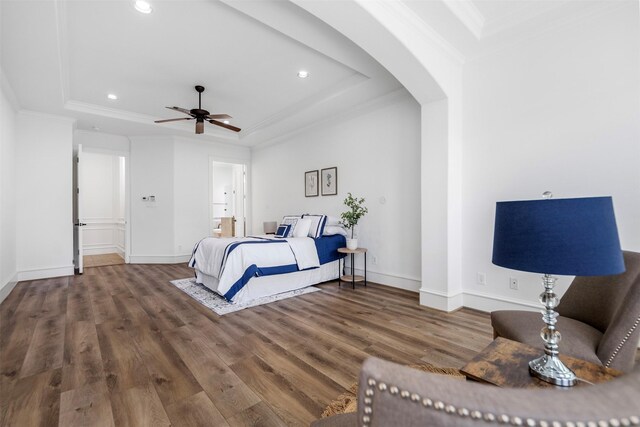 13614 Boerne Canyon Ln, Cypress, TX 77429 - bedroom featuring a tray ceiling, arched walkways, wood finished floors, recessed lighting, and baseboards