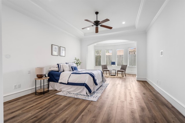 13614 Boerne Canyon Ln, Cypress, TX 77429 - bedroom with a tray ceiling, wood finished floors, arched walkways, recessed lighting, and ornamental molding