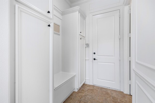 13614 Boerne Canyon Ln, Cypress, TX 77429 - mudroom featuring ornamental molding and stone finish floors