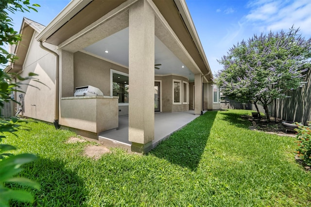13614 Boerne Canyon Ln, Cypress, TX 77429 - back of property featuring a patio, ceiling fan, stucco siding, and area for grilling